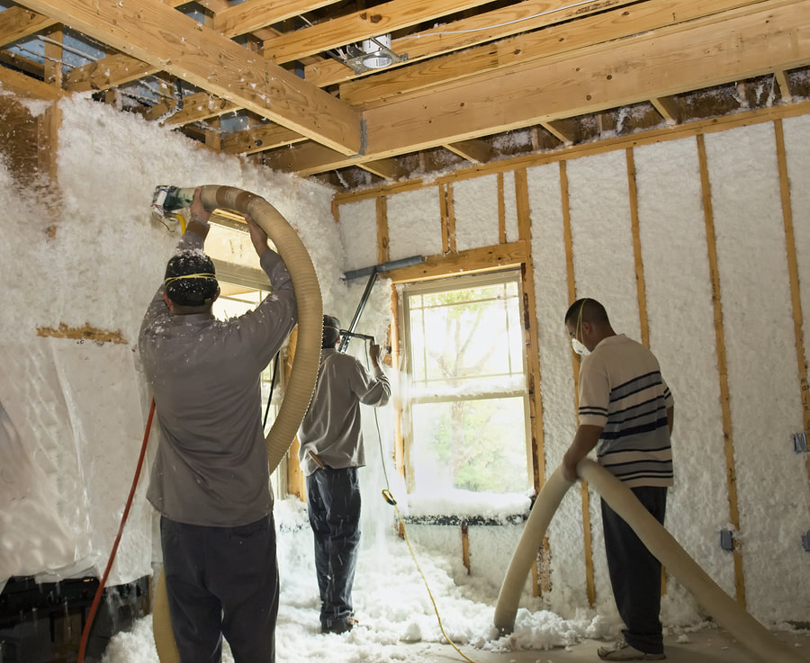 workers installing insulation in the walls